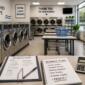 Modern self-service laundromat with commercial washers and organized supplies.